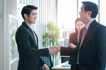 Achievement successful businessmen shaking hands after presentation at conference meeting in office, success teamwork after sign contract, business handshake agreement partnership concept