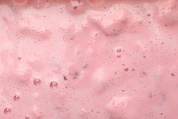 Delicious berry milkshake on whole background, close up