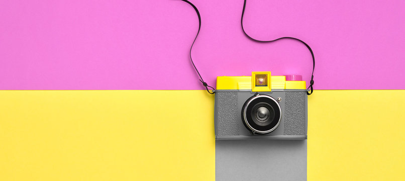 Fashion film camera. Minimal hipster summer trend flat lay. Retro design camera on vivid color. Summertime concept. Trendy fashionable film camera, creative pop art