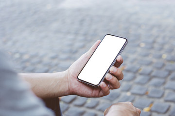 cell phone Mockup image blank white screen.man hand holding texting using mobile sitting at outdoor.background empty space for advertise.work people contact marketing business,technology