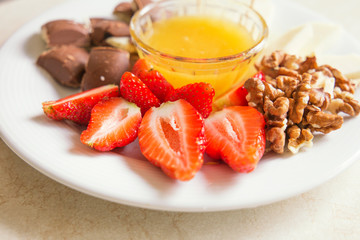
strawberries and cheese on a plate