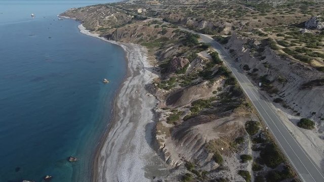 Wide aerial view of an empty beach due to quarantine during the COVID-19 pandemic ast the normally popular attraction of Aphrodite's Rock in Cyprus.