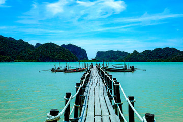 Old Wooden bridge into the sea.