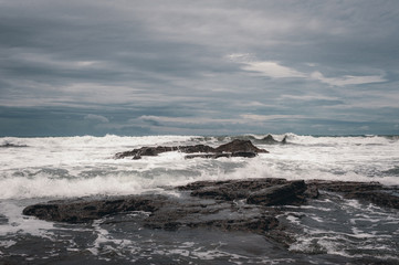 Beach and beautiful views of the cliffs, splashing waves and tropical nature.