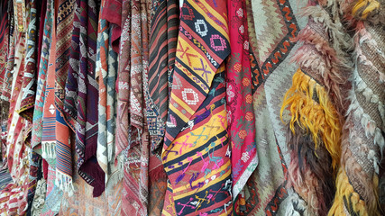 colorful wool fabric background. Traditional Turkish carpets and rugs hanging on bazaar market in Cappadocia
