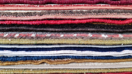 colorful wool fabric texture. Closeup of folded rugs texture. Striped pattern background