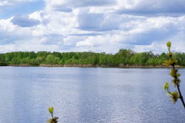Stormy sky reflected in the river and forest in the background. Before the rain