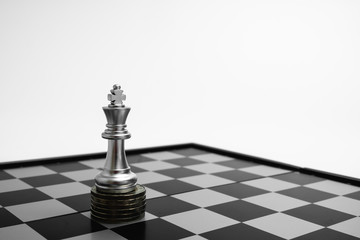 King stand higher on pile of coins, Wealth and money competitive concept.