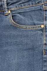 Pocket of jeans,  Close up of details of jeans trousers with orange stitches. orange seam on jeans.