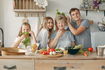 Family in a kitchen. Grandmother with grandchildren. People with vegetables