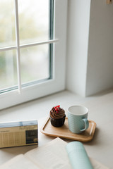 Tea and cake by the window. Dessert and tea in the kitchen. 