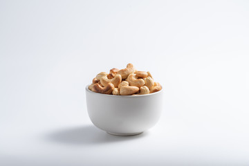 Roasted cashew nut in bowl on white background