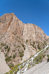The beautiful mountain trekking road with clear blue sky and rocky hills in Fann mountains in Tajikistan