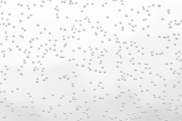 Soda sparkling drink little bubbles with glass transparent white surface background macro