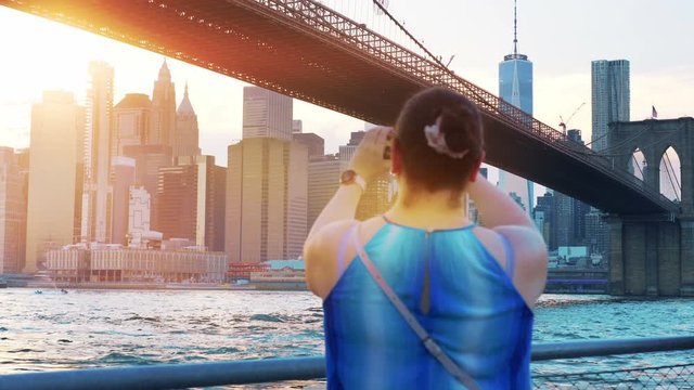 Girl Takes A Photo of New York City Brooklyn bridge in 4K Slow motion 60fps