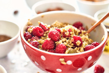 Steel cut oatmeal porridge with raspberry and nuts for breakfast