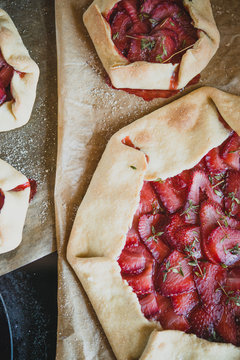 Overhead view of strawberry pie on parchment paper