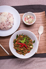 Stir fried minced pork with basil served with steamed jasmin rice and Riceberry, Pad kra pao.