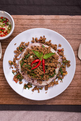Stir fried minced pork with basil served with steamed jasmin rice and Riceberry, Pad kra pao.
