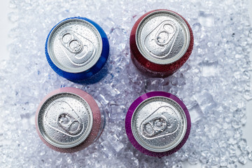 Group of aluminium cans in ice, cold drink.