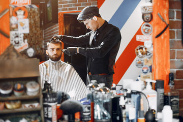 Man with a beard. Hairdresser with a client.