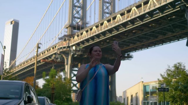 Girl Takes A Selfie on Dumbo in New York City in 4K Slow motion 60fps