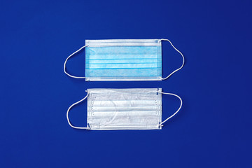 Medical face mask on blue background. Coronavirus covid-19 prevention concept