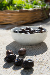 black olives cooked in the oven on a typical Apulian stone in the sun