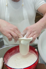 production of the typical apulian mozzarella called burrata. filling the burrata.