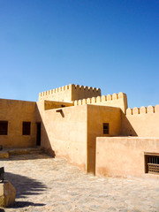 Amazing desert landscape and scenery with rocks and sand and Arabian architecture Bukha Fort near...