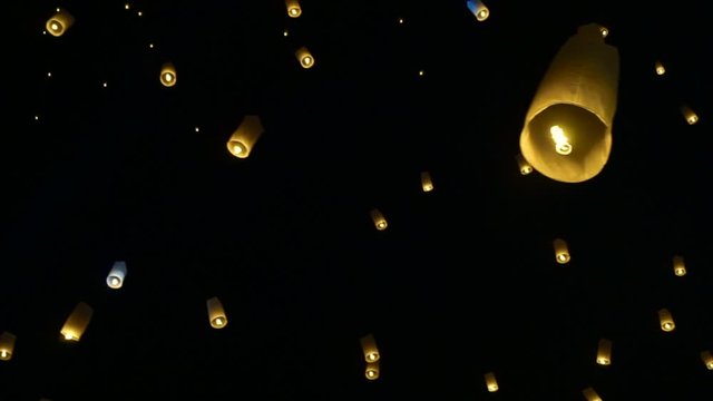 Yipeng Lanna festival during Loi krathong in Thailand laterns floating in full moon sky