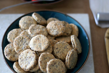 Bowl of healthy spelt flour crackers, served on a table. Selective focus.