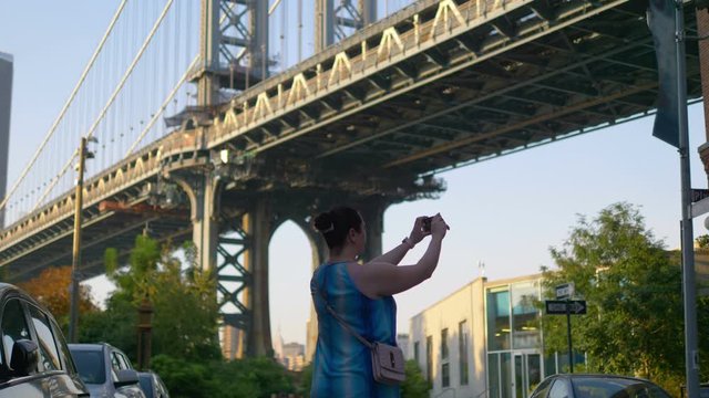 Girl Takes A Picture on Dumbo in New York City in 4K Slow motion 60fps