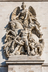 Statue on the wall of the Arc de Triomphe at the Champs-Elysees Avenue in Paris,