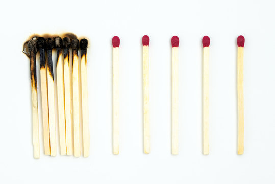 Social distancing concept using burnt out match sticks isolated on white background, prevent corona virus outbreak