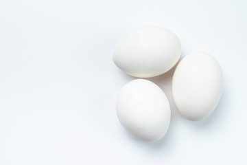 Three white chicken eggs isolated on white background