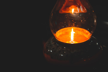 Candle light with fire frame in bottle glass.
