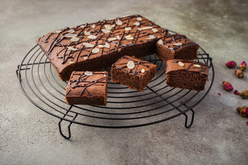 Homemade brownies with chocolate and almond petals. Close up. Horizontal orientation