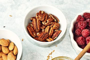 Peeled pecan nuts in the bowl on white background