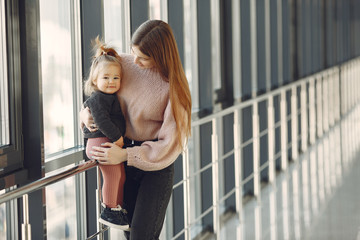Mother with daughter. Family in hall. Woman in a pink sweater.