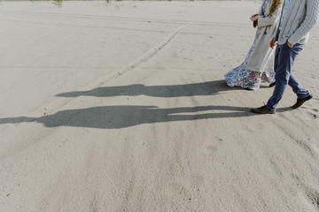 Fototapeta na wymiar Shadows of man and woman in the sand.