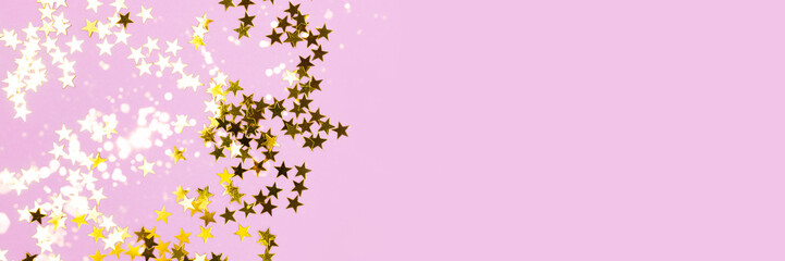 Golden stars confetti texture on a purple pastel background. Festive shiny banner with place for text.
