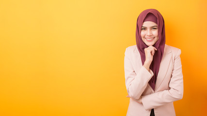 Beautiful business woman with hijab portrait on yellow background