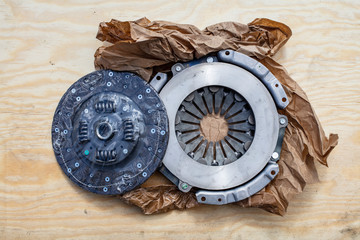 New Clutch disc and Clutch cover on top of a wooden plate in Finland.