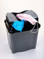 Trash can with used masks and gloves