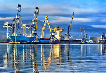 Obraz premium Port cranes in port of Novorossiysk. Industrial port landscape.