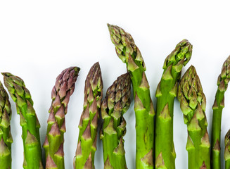 Bunch of fresh raw asparagus on white background, vegetarian concept. Green grass sparrowgrass sticks, food for veggie.