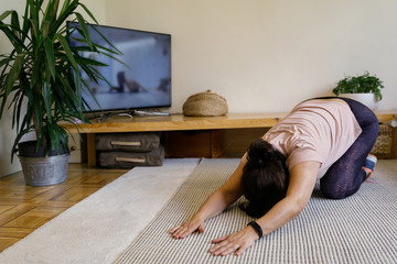 Woman doing stretching exercises at home