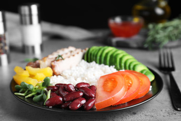 Delicious rice with beans served on grey table, closeup