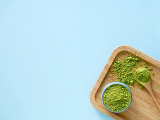matcha tea on wooden wooden salver with spoon and leaf on pink background. Concept healthy drink, detox, copyspace, flat lay, copyspase
